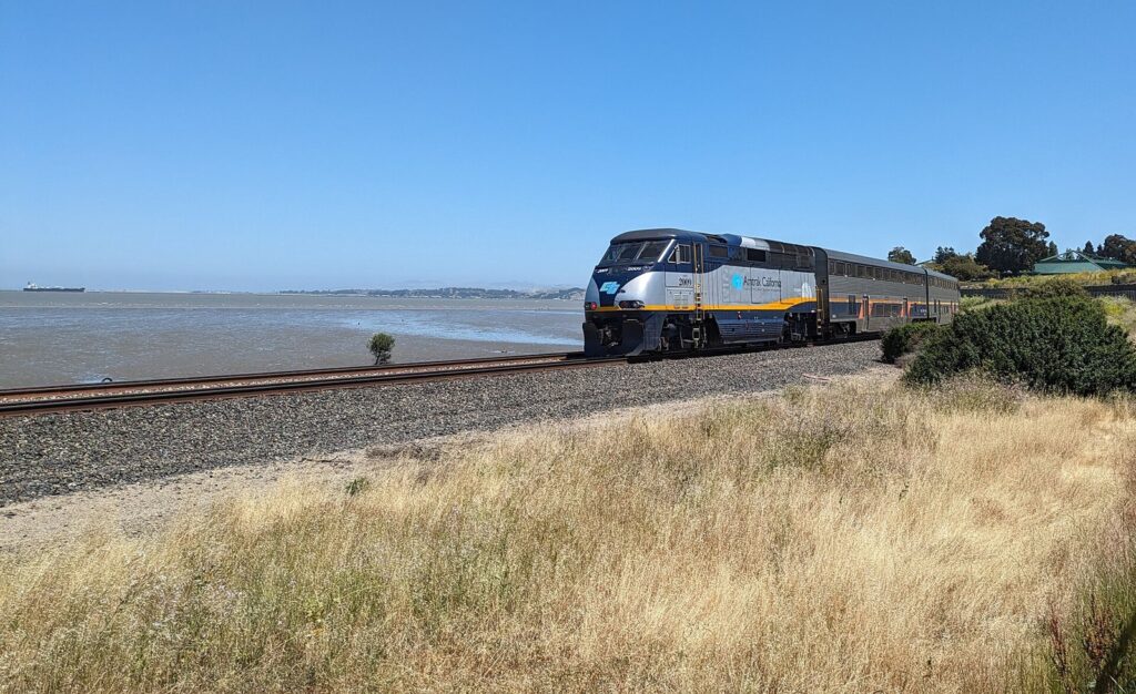An Amtrak Capitol Corridor train running along San Pablo Bay in Hercules