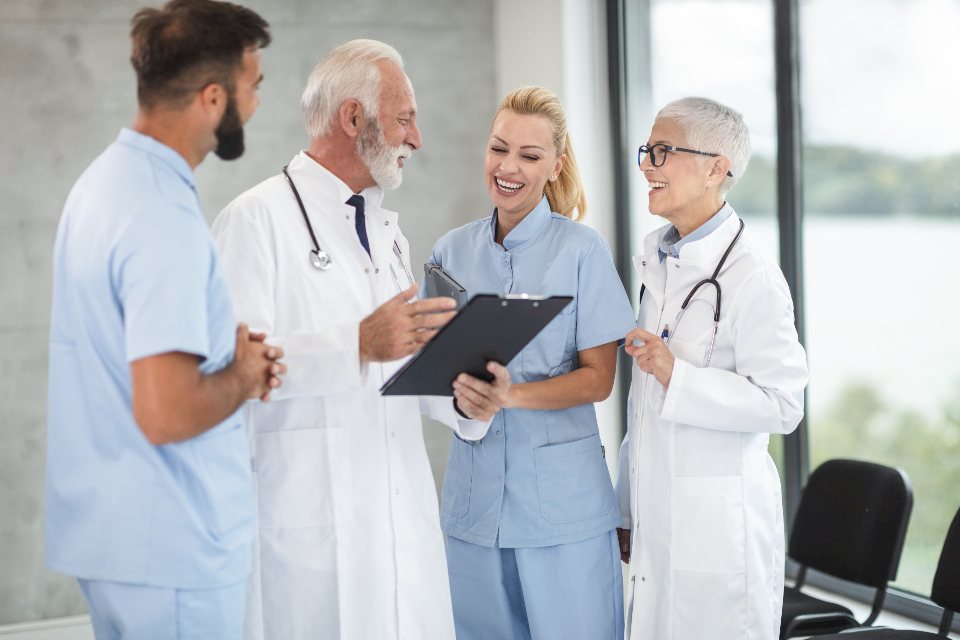 Doctors and nurses talking over a clipboard in a hospital